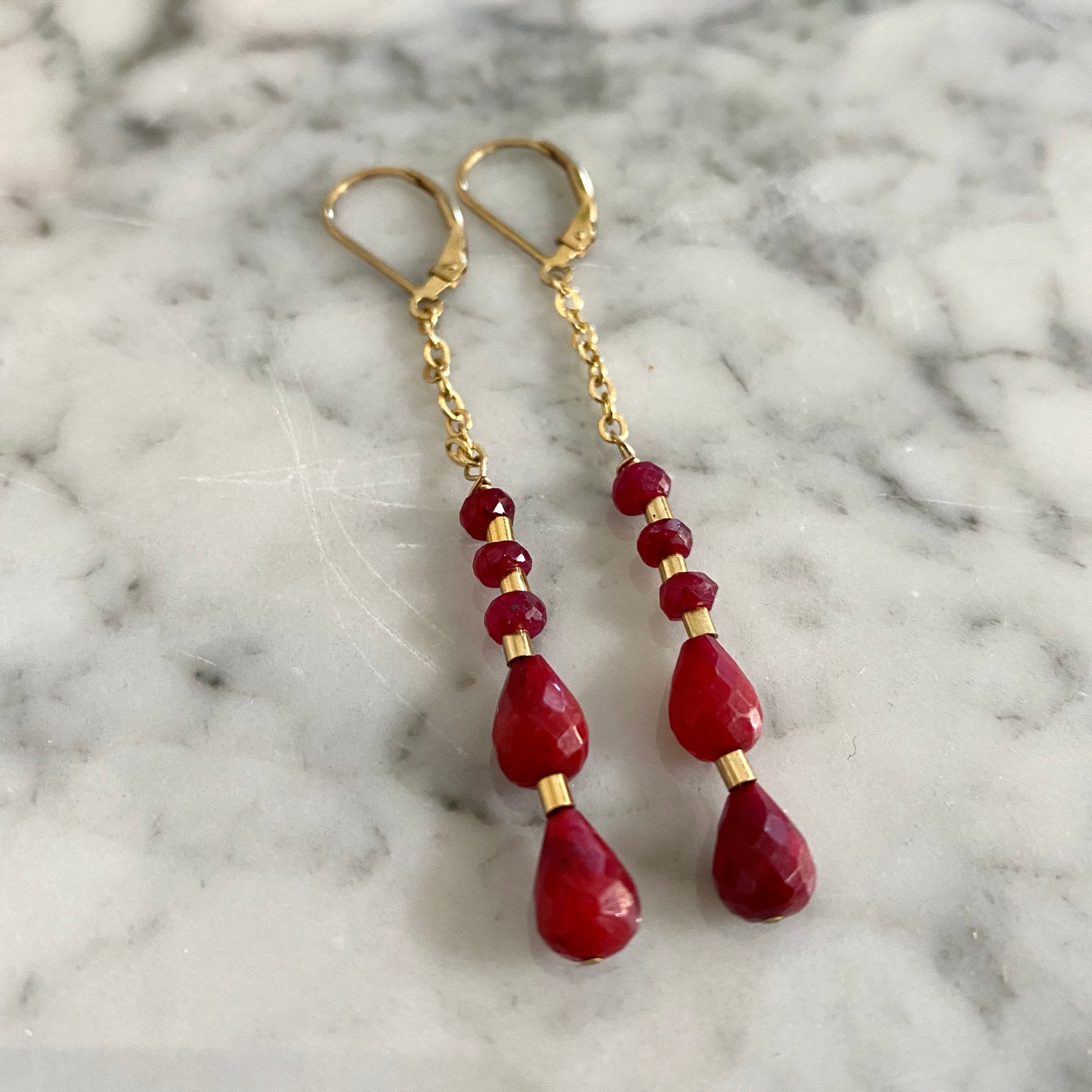 Natural ruby gold dangle earrings.