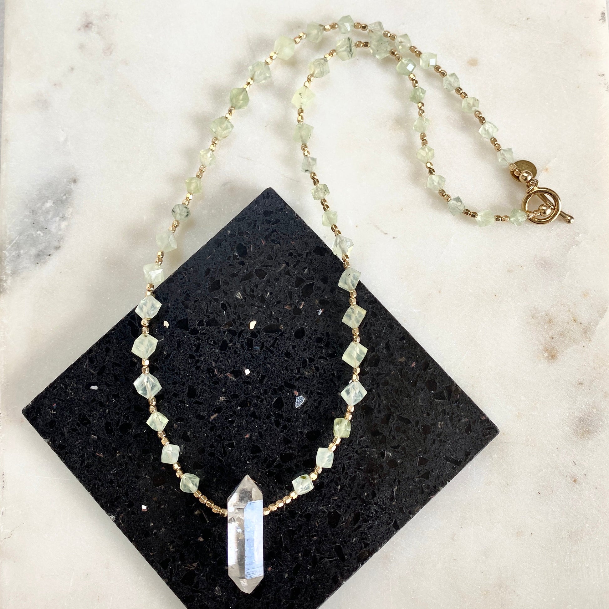 Green geometric prehnite gemstone necklace with Herkimer diamond pendant. 22.5" necklace with 14K gold toggle closure.